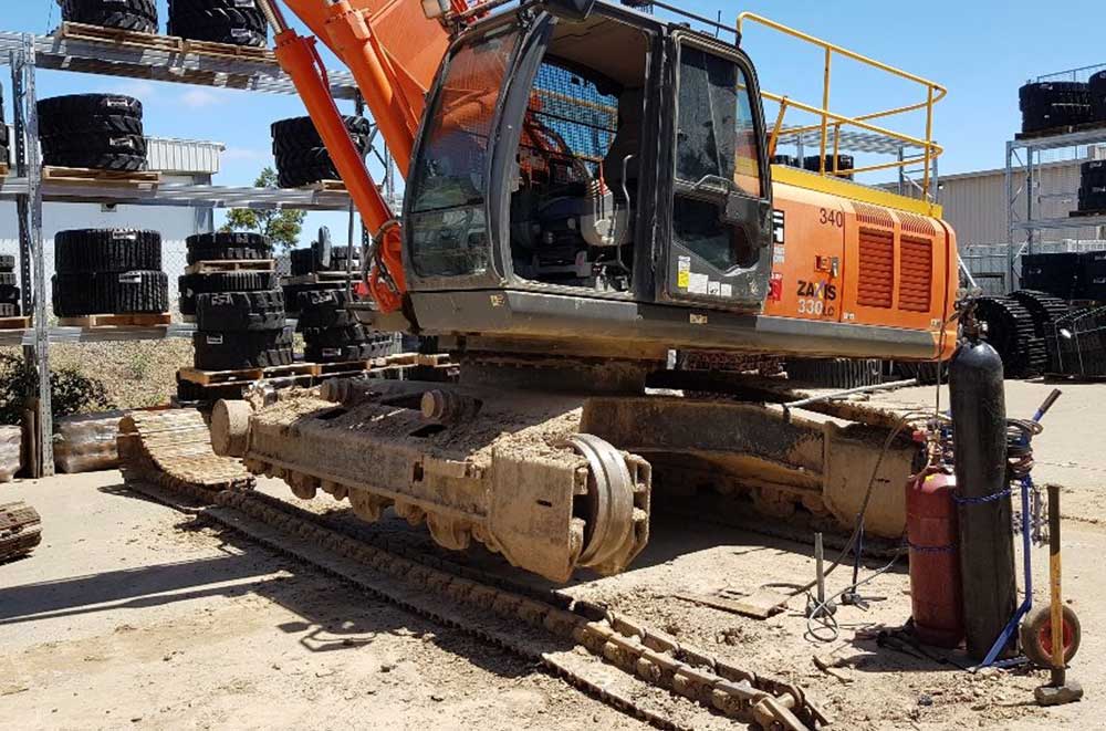 Excavator track being removed - Staying on top of your excavator’s maintenance